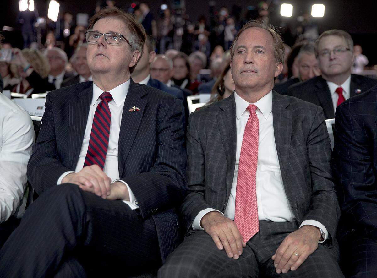 Texas Lt. Gov. Dan Patrick and Attorney General Ken Paxton listen to President Donald Trump speak at the American Farm Bureau Federation’s convention on Sunday, Jan. 19, 2020, in Austin, Texas. The president’s visit comes just two days before his impeachment trial is set to begin in the Senate.
