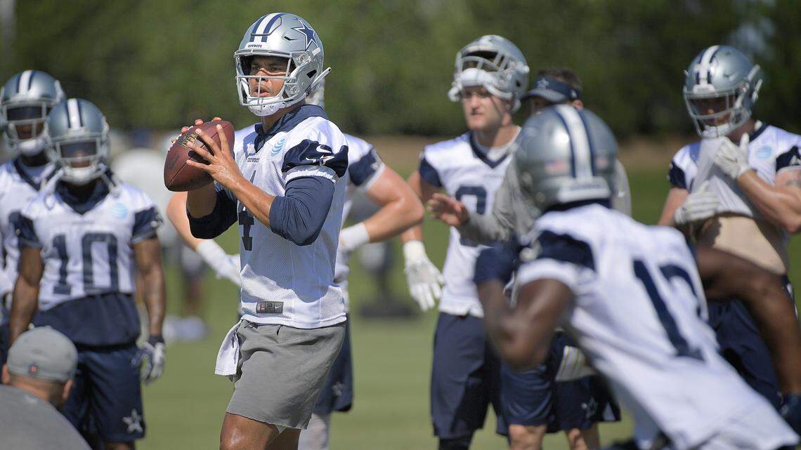 Dallas Cowboys quarterback Dak Prescott (4) drops back to pass as wide receiver Michael Gallup (13) runs a crossing route during OTA practice at Ford Center at The Star in Frisco, TX, Wednesday, June 6, 2018.  