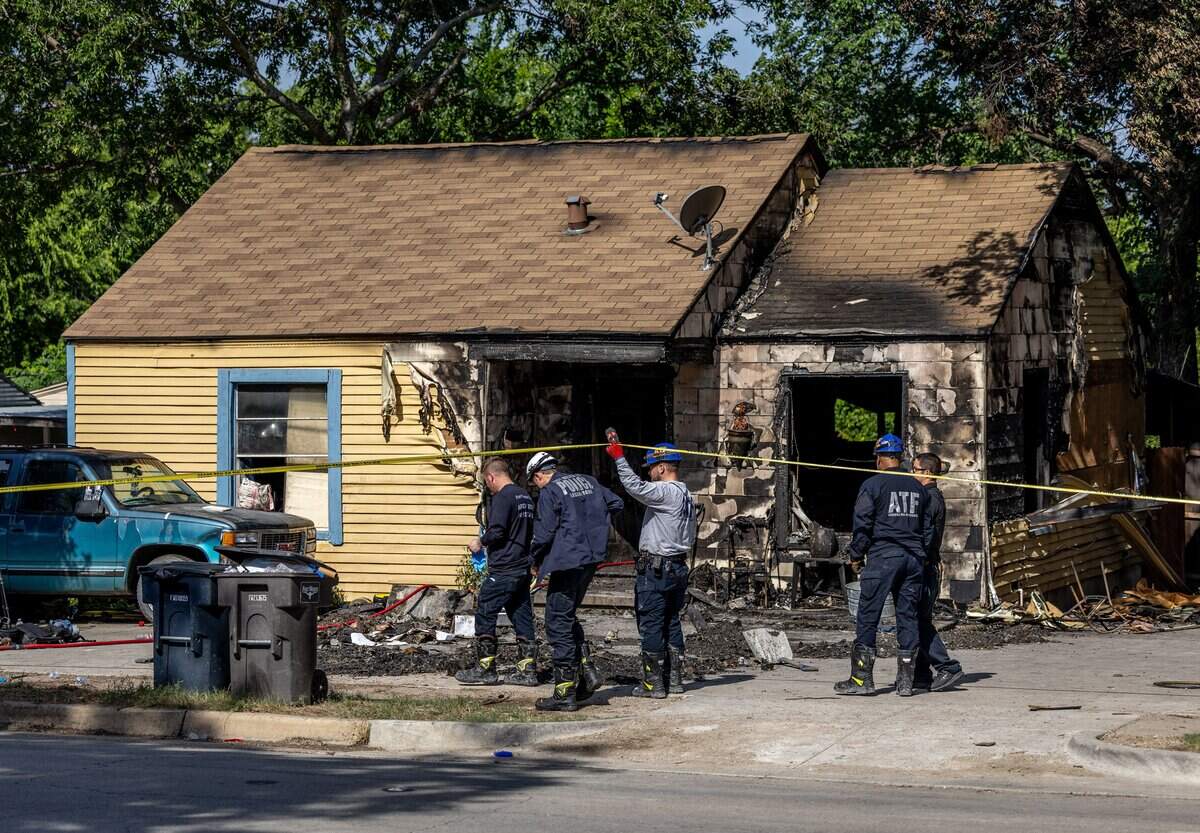 Fire investigators and firefighters pass through caution tape after a house fire in south Fort Worth on June 25, 2026.