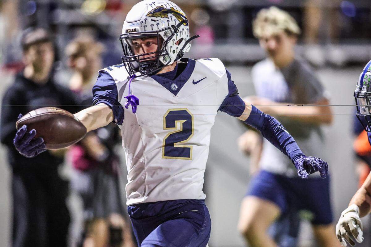 Keller receiver Ralph Crosby holds the ball over the goal line at the end of his 57-yard touchdown catch and run down the sideline at Northwest ISD Stadium in Justin, Texas, Friday, Nov. 7, 2025.