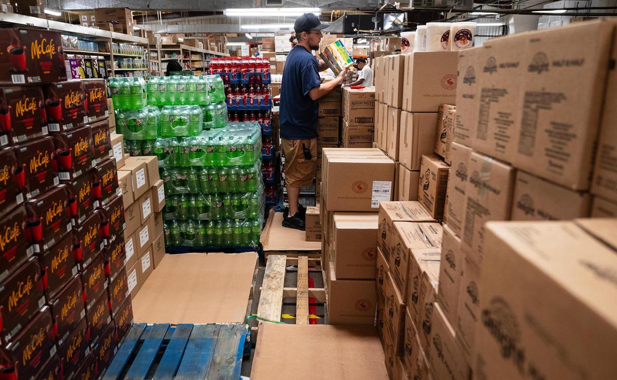 Town Talk Foods employee Andrew Stolt restocks the store after the weekend rush on Monday, April 21, 2025, in Fort Worth.