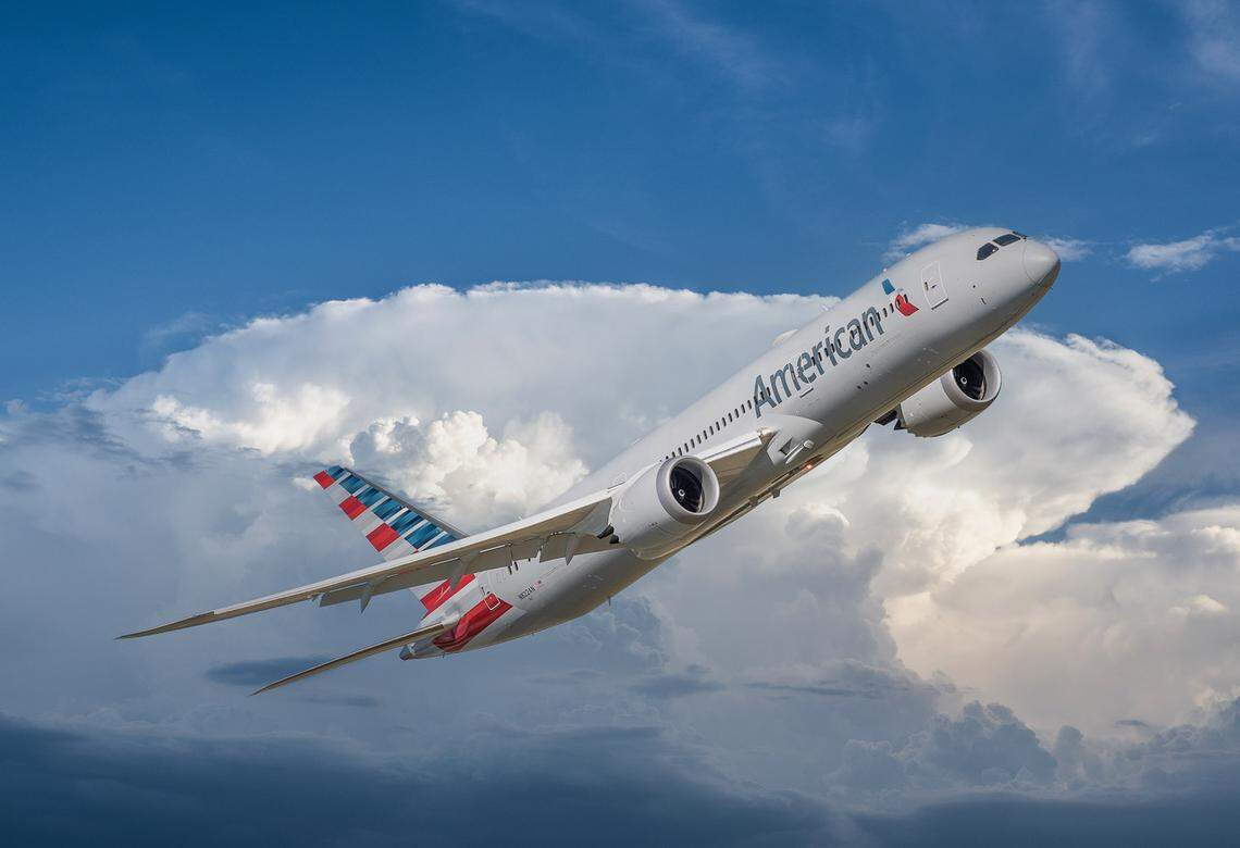 An American Airlines plane soars in the sky.
