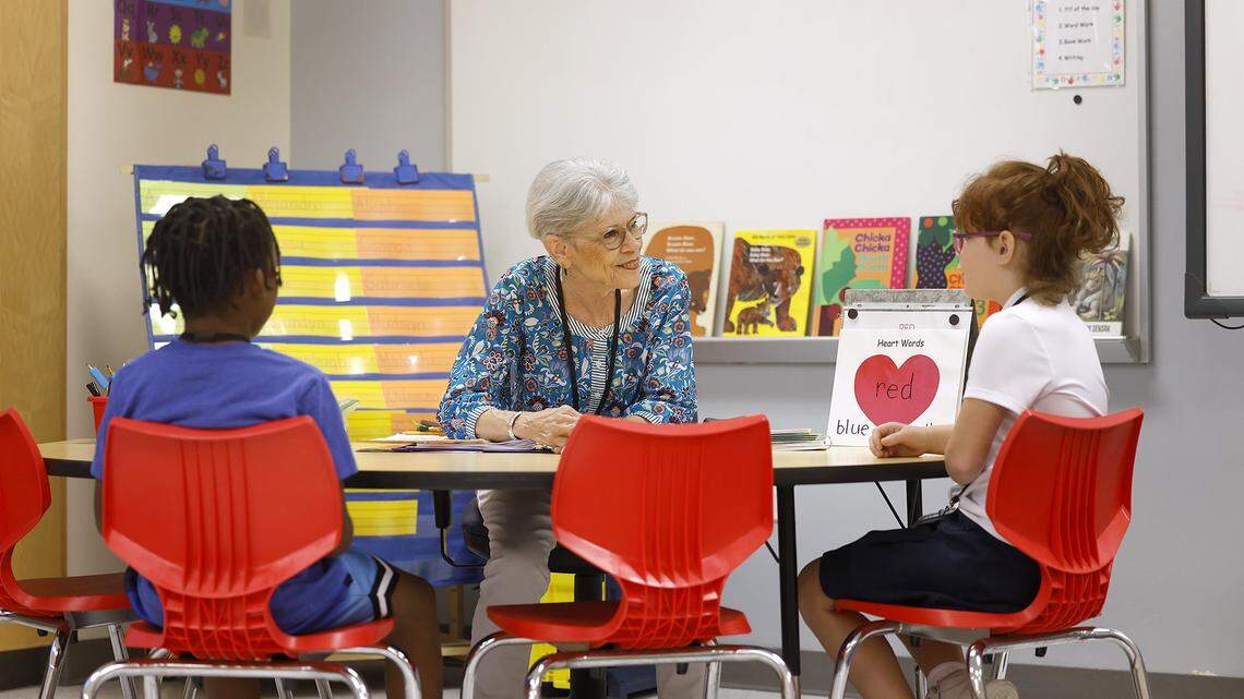 Retired teacher Martha Farr, center, tutors second graders Malachi Murkledove, left, and Gabriela Ringnald in reading at Westpark Elementary School on Thursday, Sept. 19, 2025.