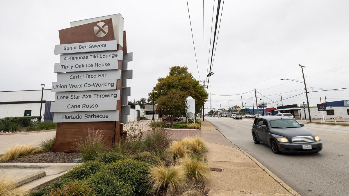 A sign listing multiple Urban Union businesses along E Division Street in Arlington. The development has expanded rapidly in recent years, inspiring confidence that downtown Arlington may soon be coming into its own.