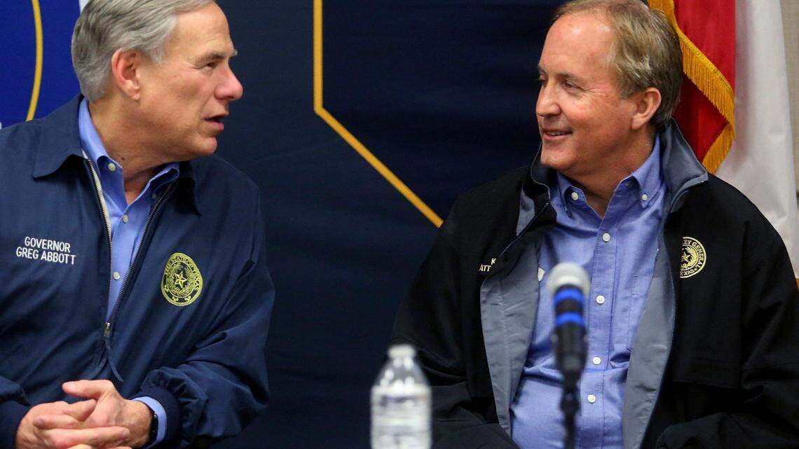 Texas Gov. Greg Abbott, left, talks with Texas Attorney General Ken Paxton after speaking to the media as Abbott campaigns at the DPS headquarters on Thursday, Jan. 27, 2022, in Weslaco, Texas. (Joel Martinez/The Monitor via AP)