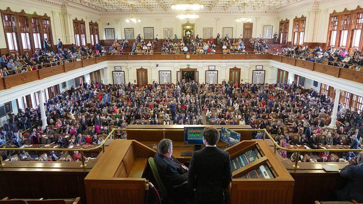 Texas House members with family and guests crowd the House Chamber at the Texas Capitol for the opening of the 88th Texas Legislative Session in Austin, Texas, Tuesday, Jan. 10, 2023.