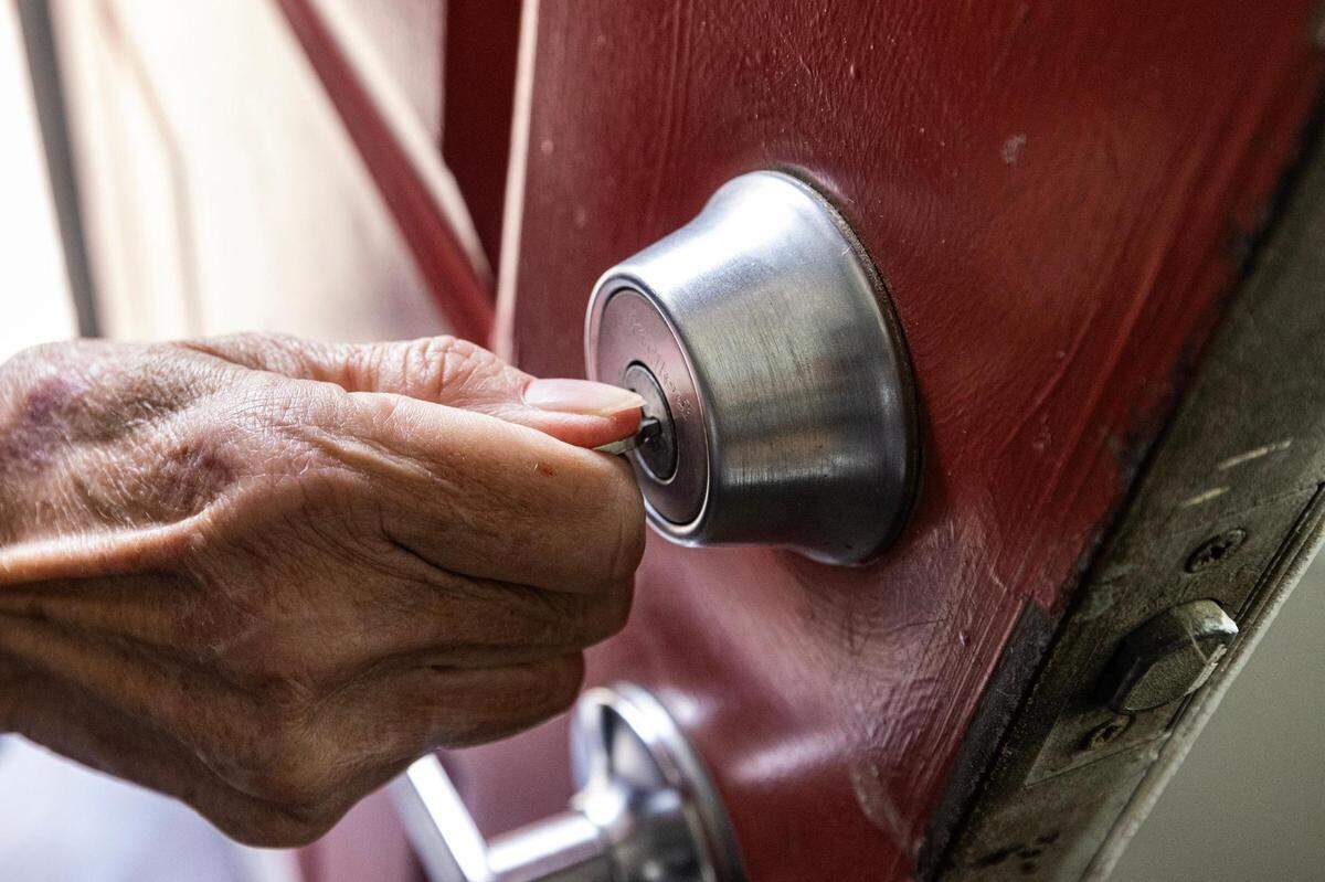 Carol Rogers turns the key to enter their new apartment in Saginaw on Tuesday, Nov. 21, 2023.