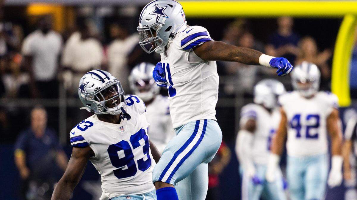 Dallas Cowboys Micah Parsons celebrates a second sack with Tarell Basham during the first half of Sunday’s game against Tampa Bay at AT&T Stadium in Arlington.