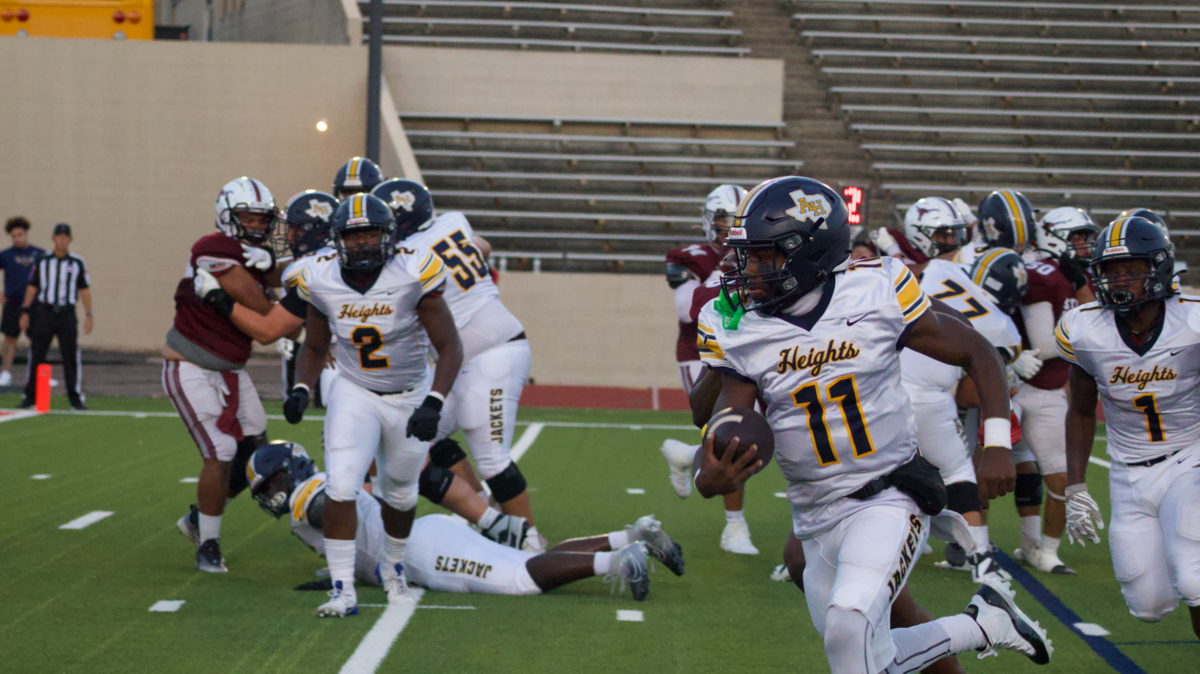 Quarterback Kaeden Grant (11) from Arlington Heights scores a running touchdown during a high school football game against North Side at Farrington Field in Fort Worth, Texas Friday, September 13, 2024. Arlington Heights won 69-0.