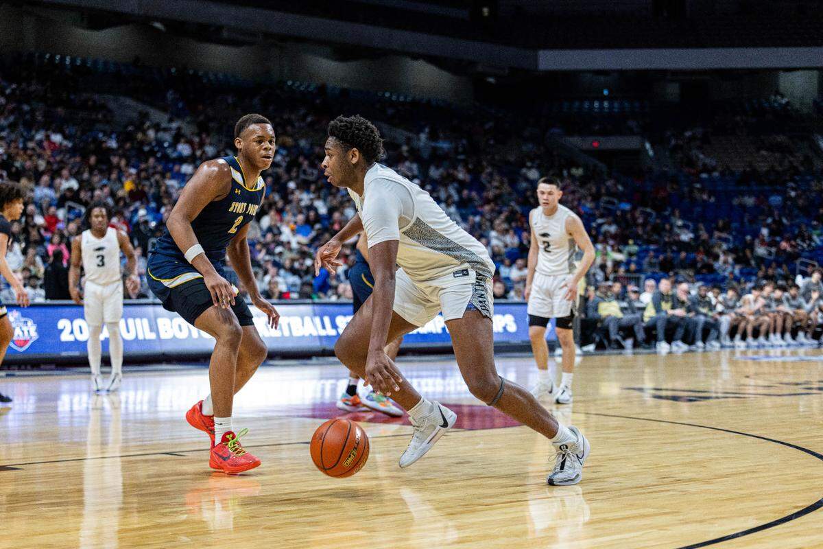 Plano East forward DJ Hall (0), the Championship Game MVP, drives to the basket against Josiah Moseley (2) of Round Rock Stony Point in the Class 6A state championship game on Saturday, March 9, 2024 at the Alamodome in San Antonio, Texas. Plano East defeated Stony Point 53-41.