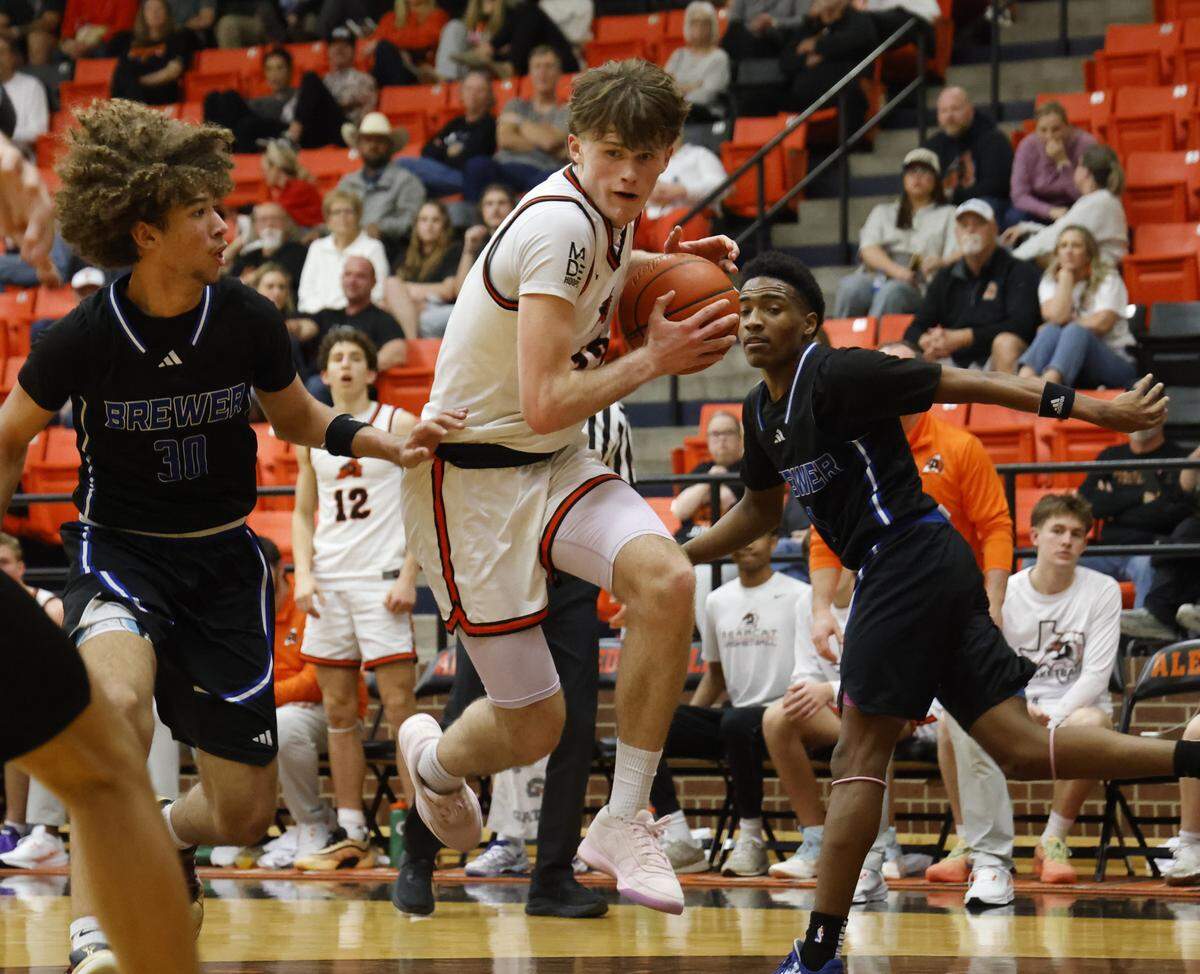 Aledo guard Ryan Lotter (23) os fouled by Brewer center Jayden Johnson (30) during the second half of a UIL boys basketball game at Aledo High School in Aledo, Texas, Friday Feb. 13, 2026.