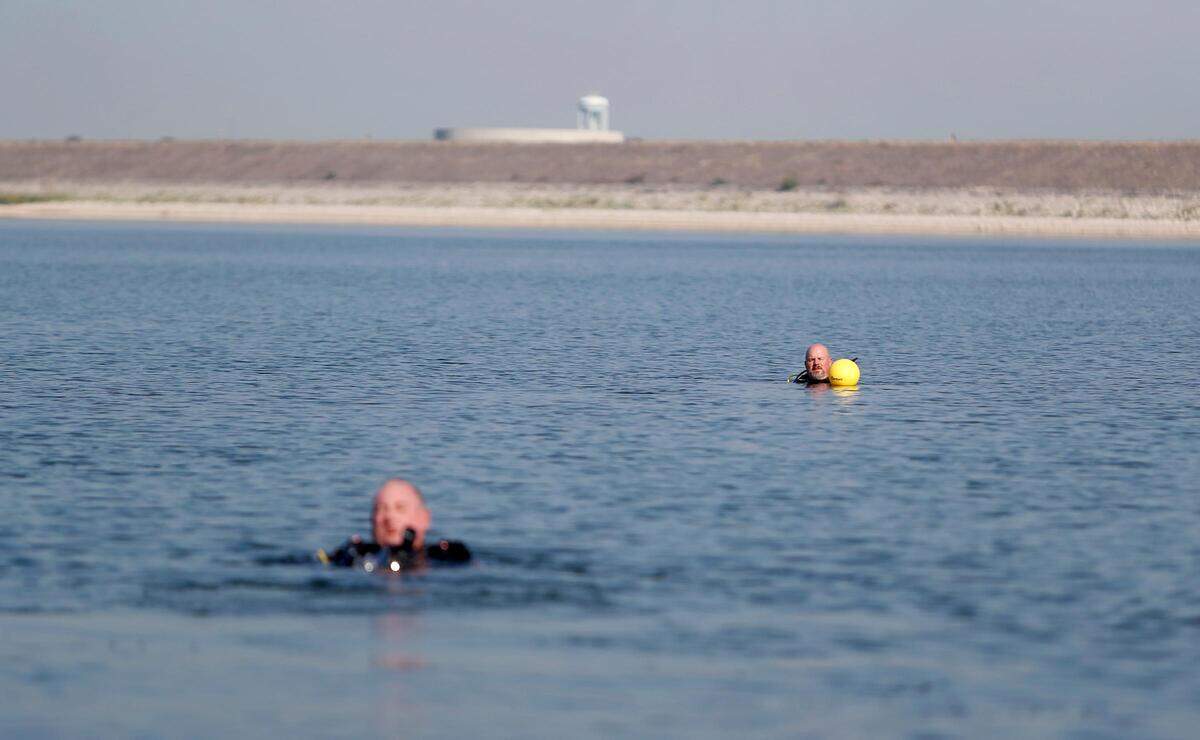 Divers Wayne Spears, left, and David Wardlaw prepare to search for the third and final submerged car in Benbrook Lake, located over 30 feet underwater on Monday, September 16, 2019. North Texas Marine Salvage & Recovery’s dive team volunteered to assist Rusty Arnold in retrieving the cars from the bottom of the lake in his search for clues to his sister’s 1974 disappearance.