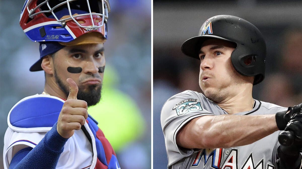 New Houston Astros catcher Robinson Chirinos (left) and Miami Marlins catcher J.T. Realmuto (right) are pictured together in this composite photo.