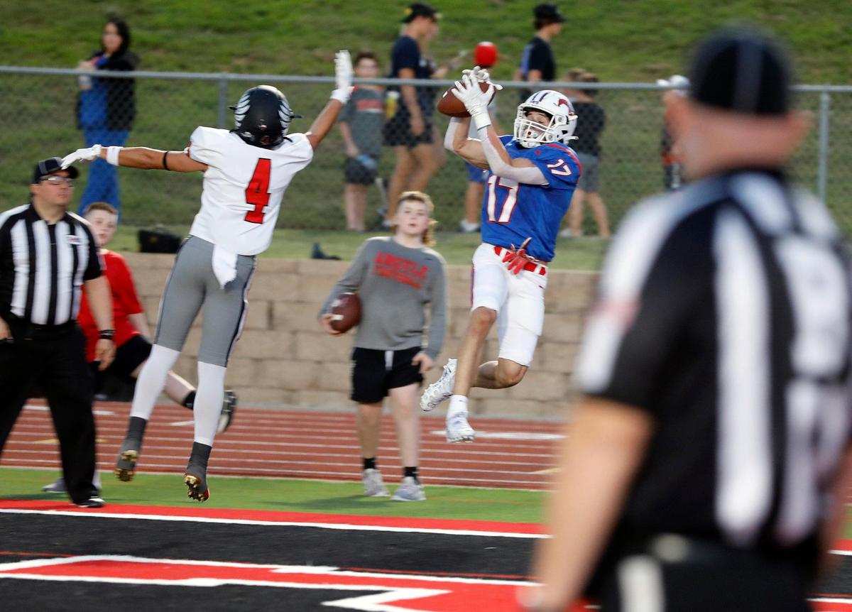 Grapevine wide receiver Sammy Kelley (17) makes the catch in front of Argyle defensive back Colton Roquemore (4) for the Mustangs only first half score to put them in the lead with 34 seconds remaining in a high school football game at Mustang-Panther Stadium in Colleyville, Texas, Friday, Sept. 09, 2022. Grapevine led Argyle 7-6 at the half. (Special to the Star-Telegram Bob Booth)