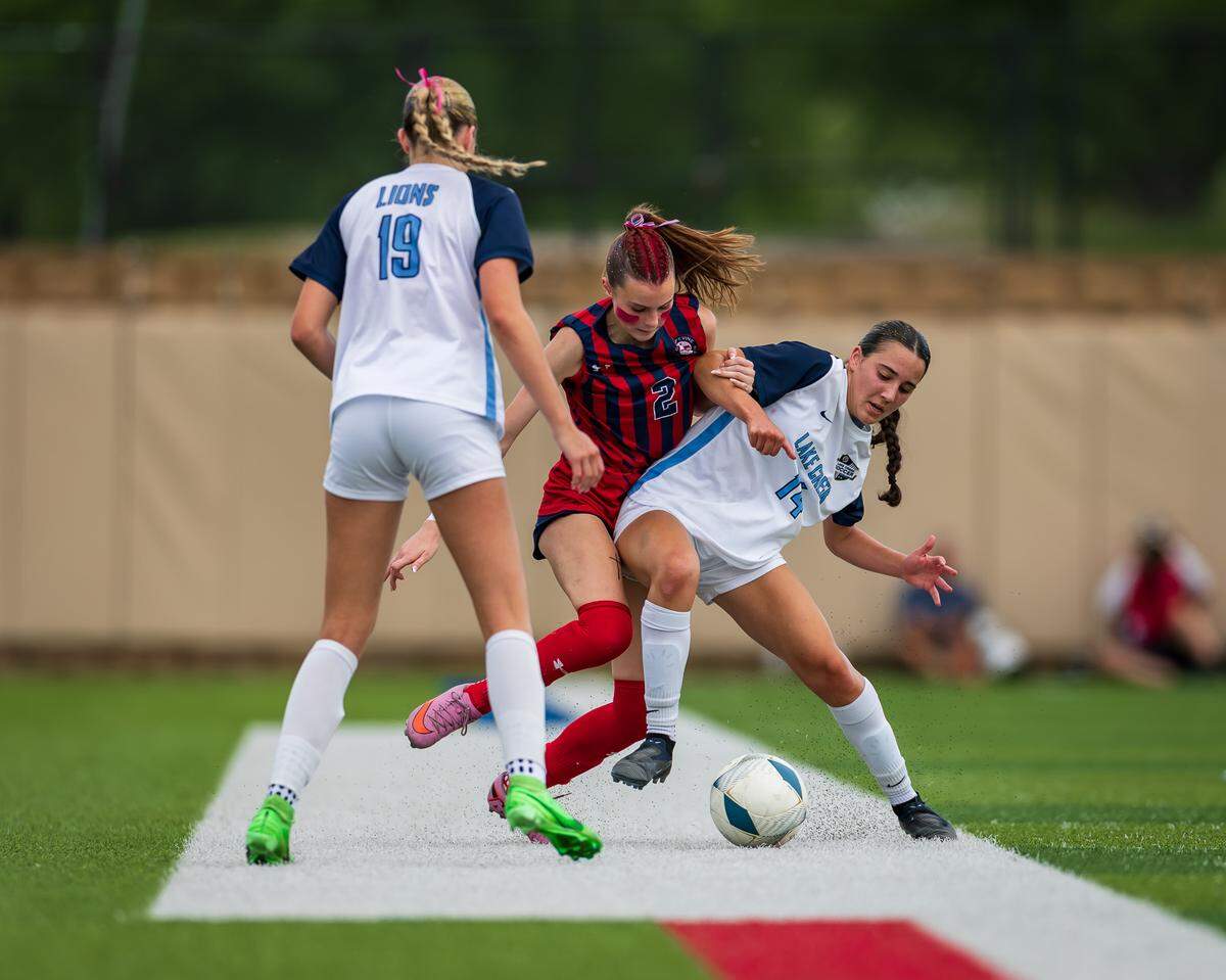 Grapevine’s Chloe O’Steen (2) battles with Montgomery Lake Creek’s Cate Rubin (14) and Rylee Struyk (19) in the UIL Class 5A Division II state soccer championship game on Friday, April 10, 2026, at Birkelbach Field in Georgetown, Texas.