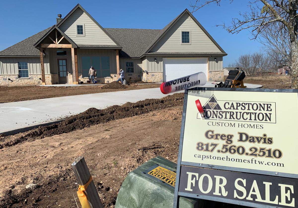 One of Greg Davis’ Capstone Homes under construction southwest of Fort Worth. This home has a water well, but adjacent properties might not be eligible for one because of state law changes.