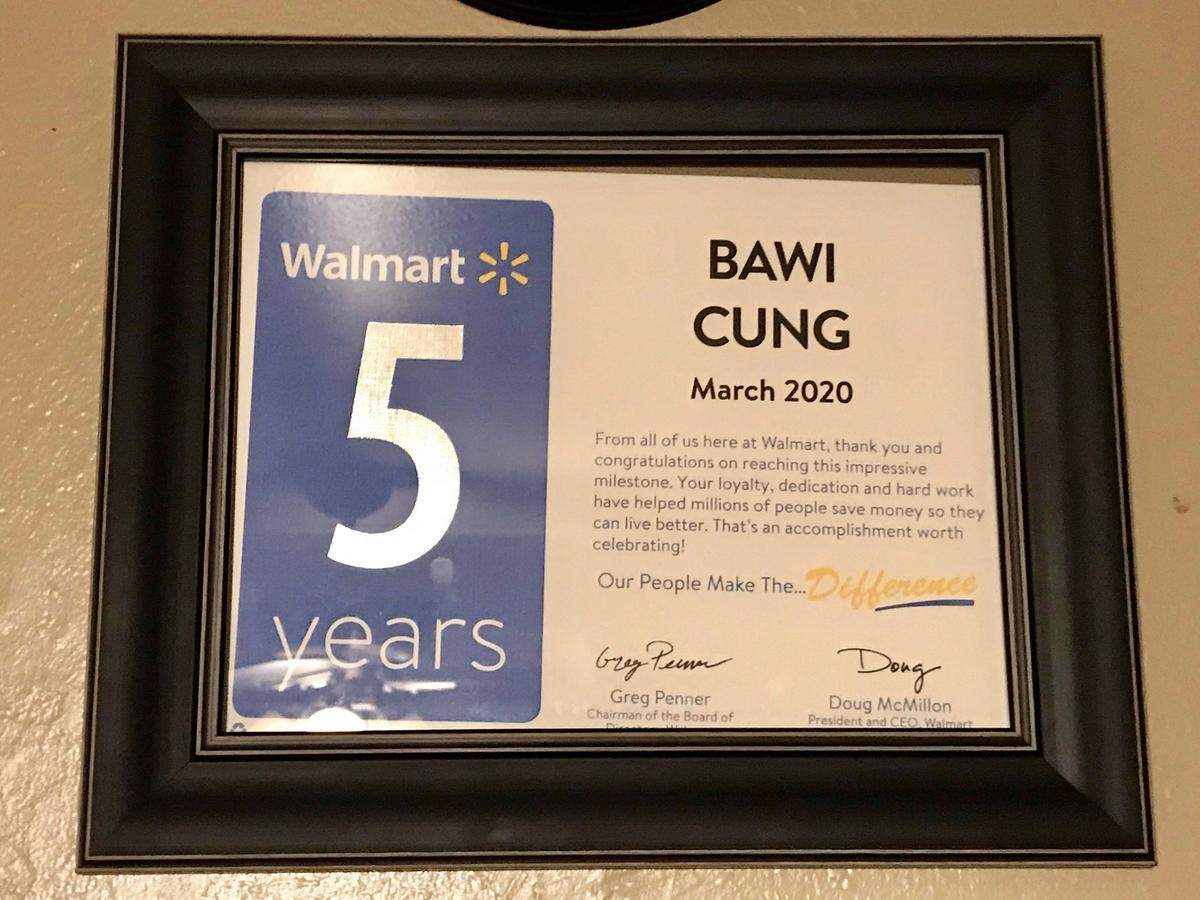 Bawi Cung’s 5-year honor from Wal-Mart hangs on his wall.