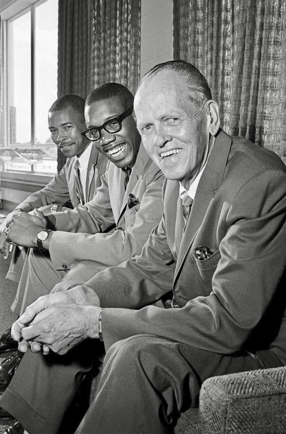 James Cash, center, signed a letter of intent with TCU Basketball Coach Buster Brannon and the I. M. Terrell all-stater became the first to break the color line in Southwest Conference basketball. Cash’s coach, Robert Hughes, is pictured at left.