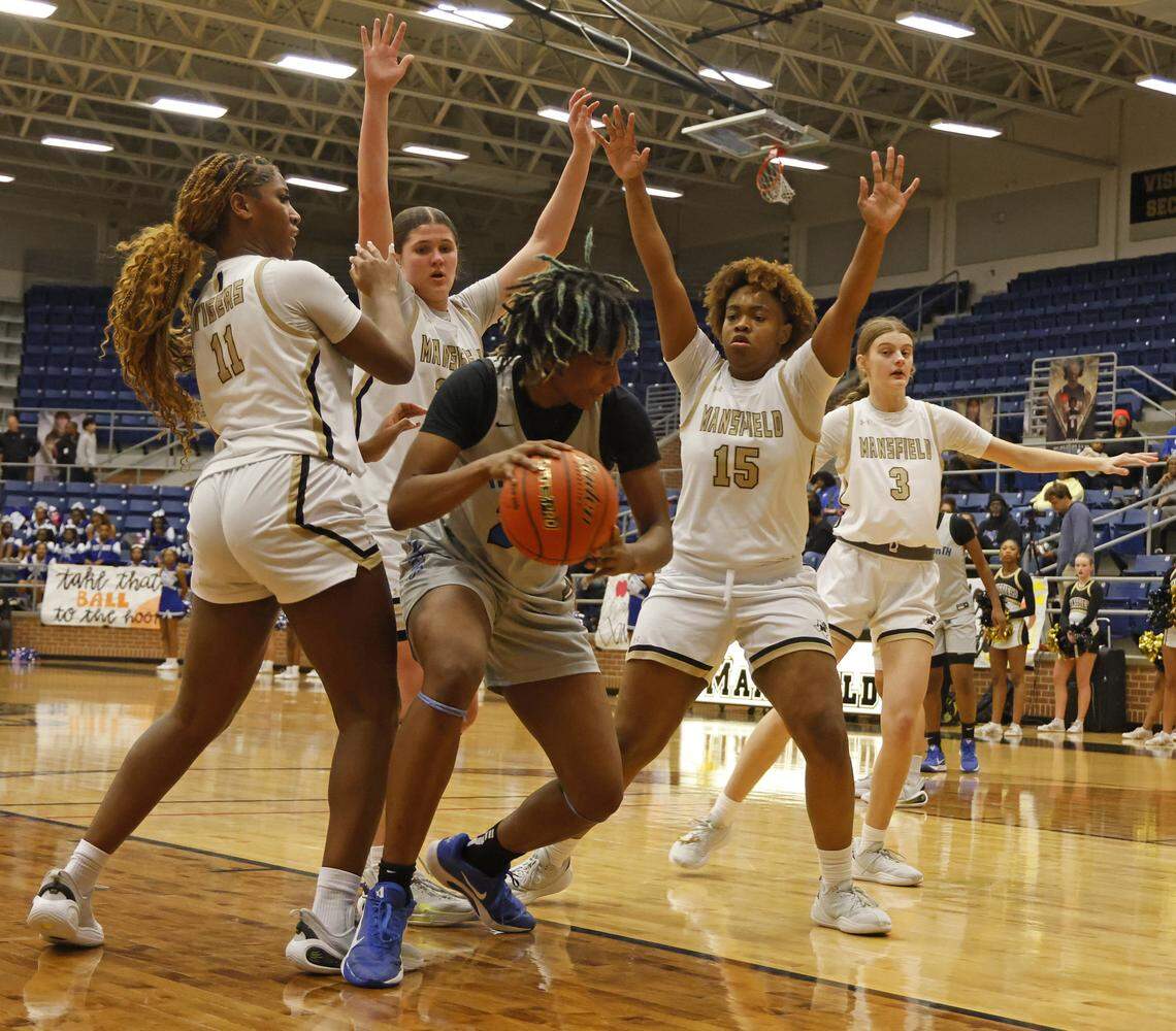 North Crowley forward Mecca Crawford (23) gets boxed in under the net during the first half of a UIL girls basketball game between North Crowley and Mansfield at Mansfield High School in Mansfield, Texas, Tuesday Jan. 20, 2026