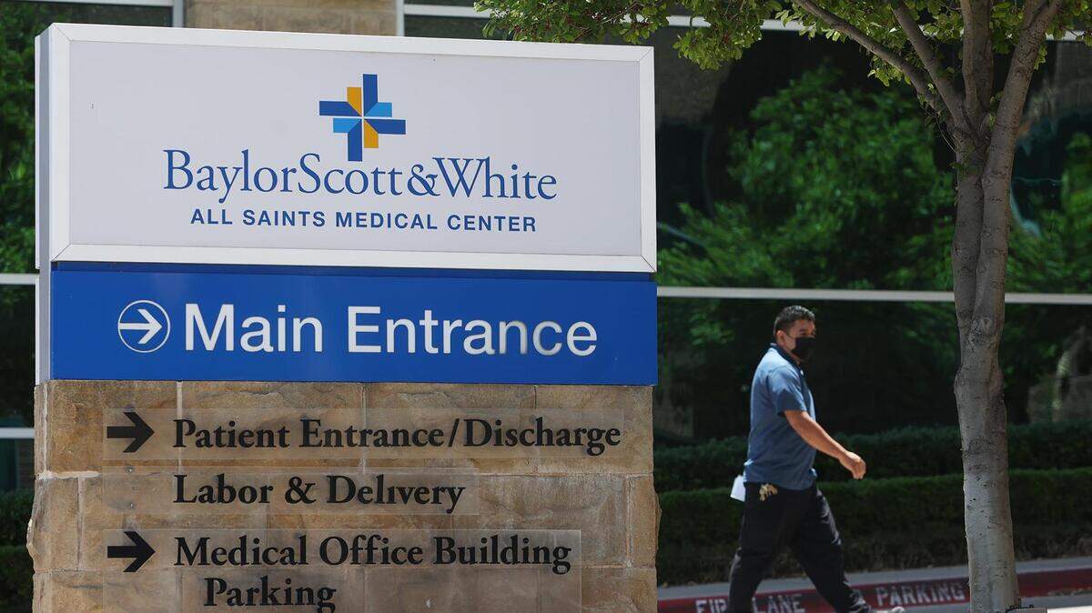 A man walks towards the main entrance of Baylor Scott & White All Saints Medical Center on Thursday, May 12, 2022, in Fort Worth. Tarrant County approved issuing more than $1 billion in bonds to benefit the health system Tuesday.