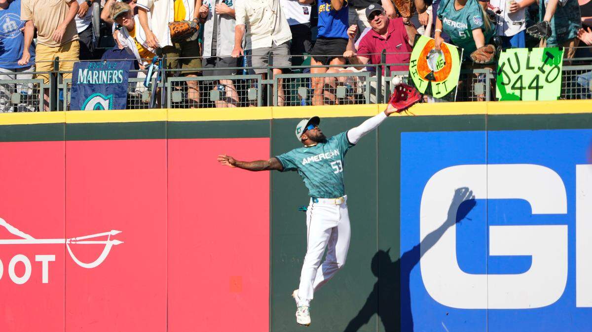 Adolis García, of the Texas Rangers, (53) grabs a fly ball by Ronald Acuña Jr., of the Atlanta Braves, during the first inning of the MLB All-Star baseball game in Seattle on Tuesday.