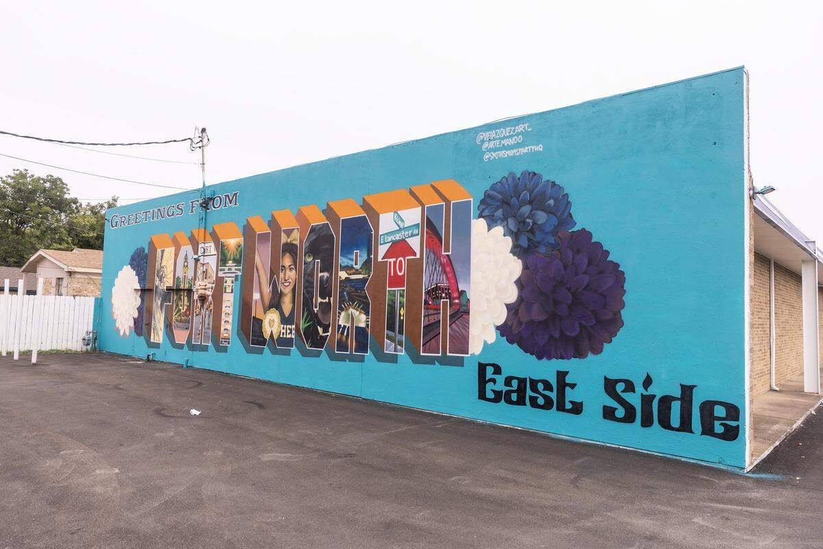  A brightly colored mural on the side of a building says “Fort Worth” in large letters and “East Side” below.