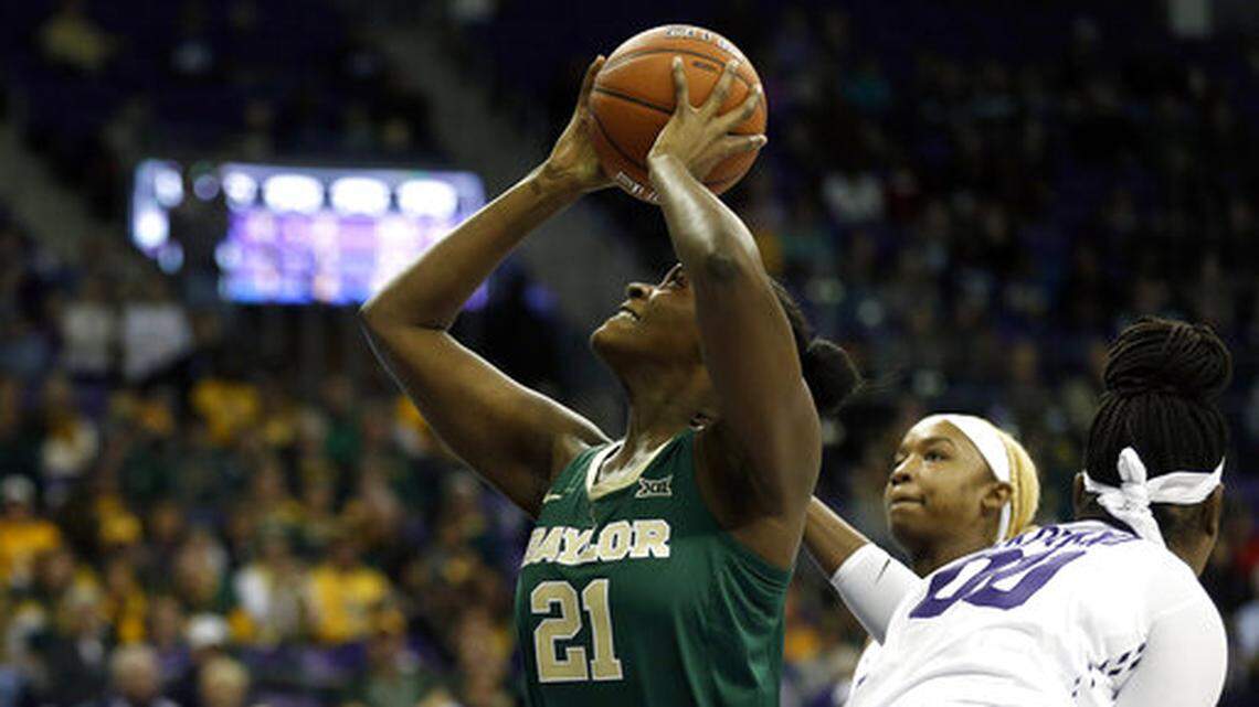 Baylor center Kalani Brown (21) looks to shoot after getting past TCU forward Amy Okonkwo (00) during the first half of an NCAA college basketball game Saturday, Jan. 12, 2019, in Fort Worth, Texas. (AP Photo/Ron Jenkins)