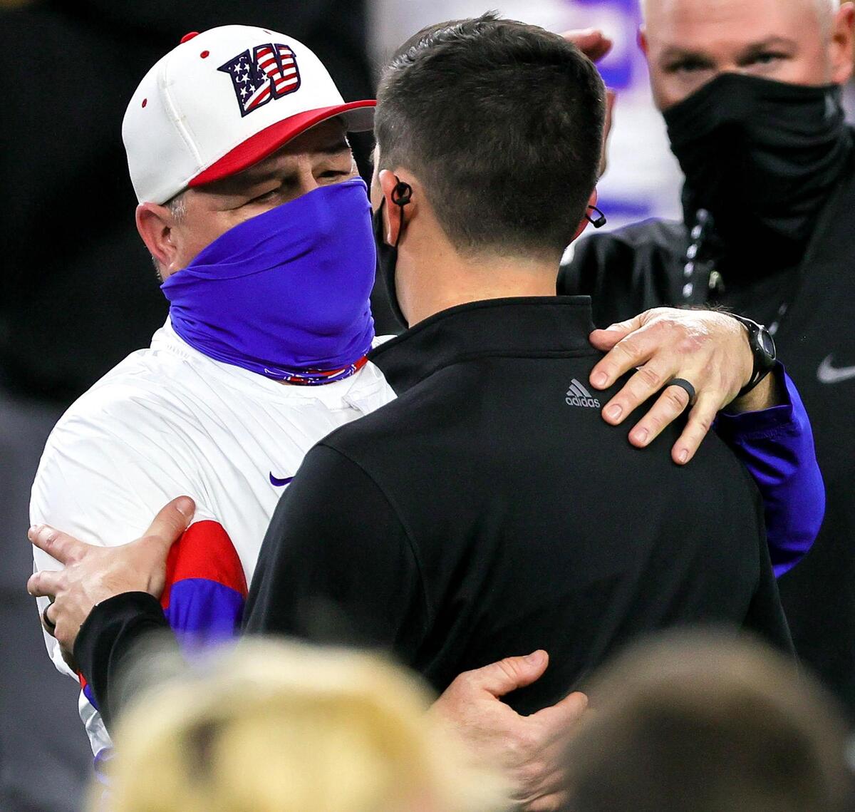 Austin Westlake head coach Todd Dodge (L) gives a hug to his son Riley Dodge, head coach of Southlake Carroll after Westlake defeated Southlake, 52-34 in the 6A Division 1 High School State Championship football playoff game, January 16, 2021 played at AT&T Stadium in Arlington, Tx. (Steve Nurenberg Special to the Star-Telegram)