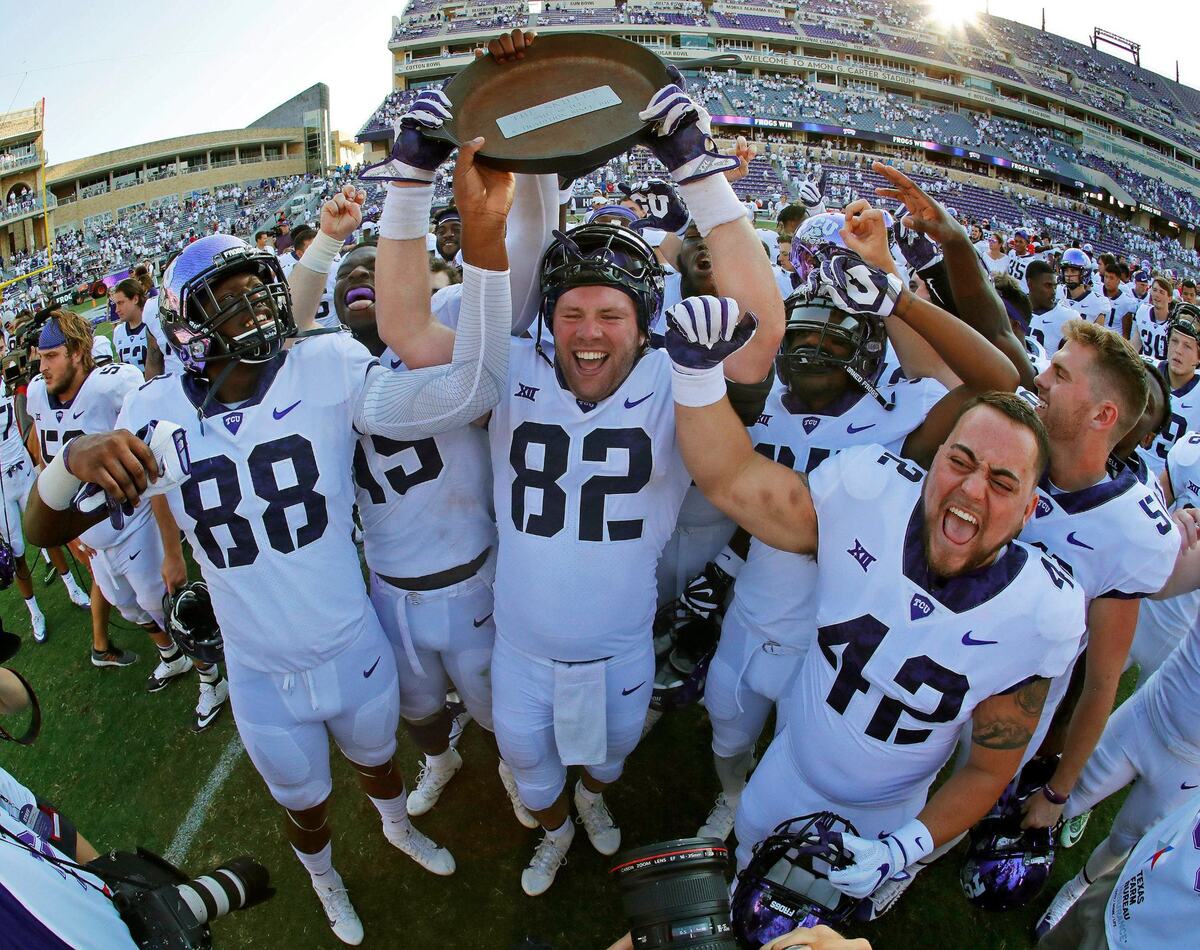 TCU Horned Frogs tight end Charlie Reid (82) hoists the Iron Skillet after TCU beat SMU 56-36 in their annual game in Fort Worth, Saturday, September 16, 2017.