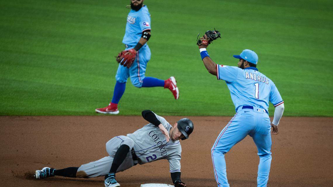 Texas Rangers Elvis Andrus tags out a Colorado Rockies player at second base Sunday, July 26, 2020, at Globe Life Field.
