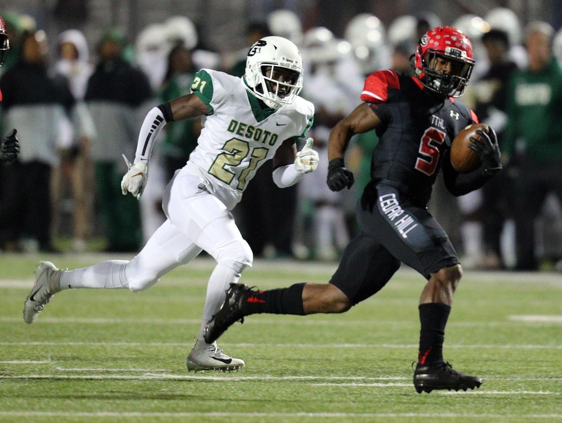 DeSoto’s Jyison Hill (22) pursues Cedar Hill’s Kevin Young (5) on a touchdown run during a high school football game at Longhorn Stadium in Cedar Hill, Texas, Thursday, Nov. 7, 2019.