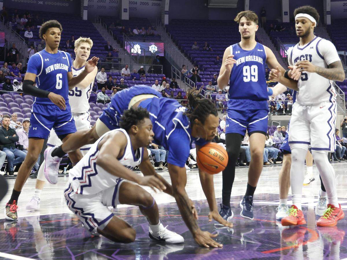 New Orleans center Churchill Abass (9) jumped and came down hard on TCU guard Jayden Pierre (1) for a foul during the second half of a NCAA basketball game between New Orleans University and TCU at Schollmaier Arena in Fort Worth, Texas, Monday Nov. 03, 2025. The Horned Frogs dropped their home opener 78-74 to the Privateers.