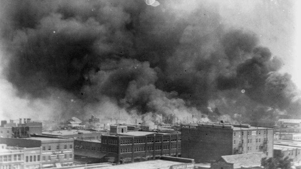 In this 1921 image provided by the Library of Congress, smoke billows over Tulsa, Okla. For decades, when it was discussed at all, the killing of hundreds of people in a prosperous black business district in 1921 was referred to as the Tulsa race riot. Under new standards developed by teachers for approaching the topic, students are encouraged to consider the differences between labeling it a “massacre” instead of a “riot,” as it is still commemorated in state laws. (Alvin C. Krupnick Co./Library of Congress via AP)