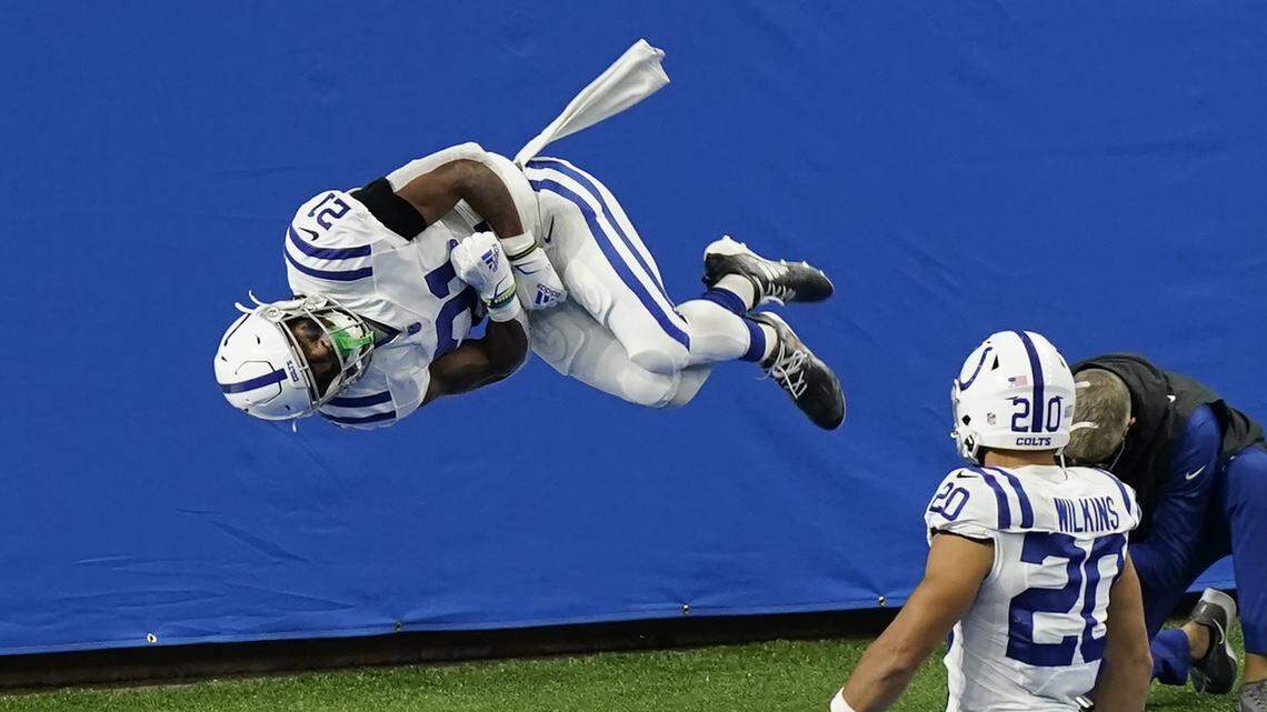 Indianapolis Colts running back Nyheim Hines (21) performs a somersault after a 22-yard run for a touchdown during the first half of an NFL football game against the Detroit Lions, Sunday, Nov. 1, 2020, in Detroit. (AP Photo/Carlos Osorio)