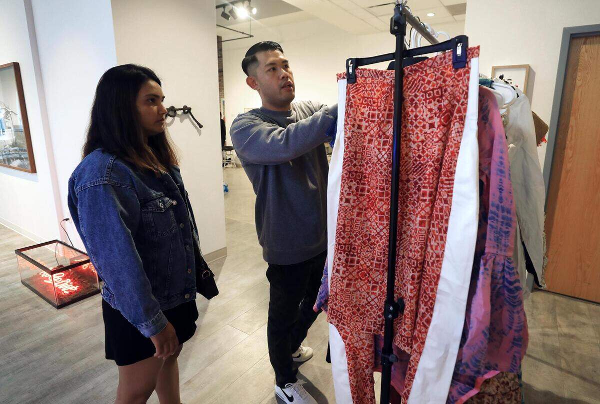 Local designer Twinkle Patel, left, and Phillip Maximilian, organizer of Fort Worth’s first fashion week, go through her collection during a run through and fitting on Feb. 20. Patel and her collection for fashion brand Shein was featured during the inaugural Fort Worth Fashion Week.