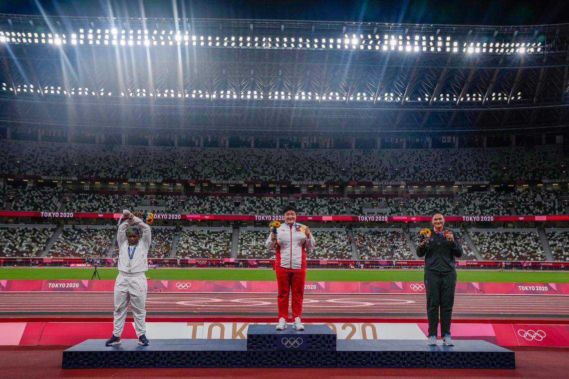 China’s Lijia Gong, center, poses with her gold medal after winning women’s shot put next to Raven Saunders, of the United States, left, silver medal, and New Zealand’s Valerie Adams, bronze medal.