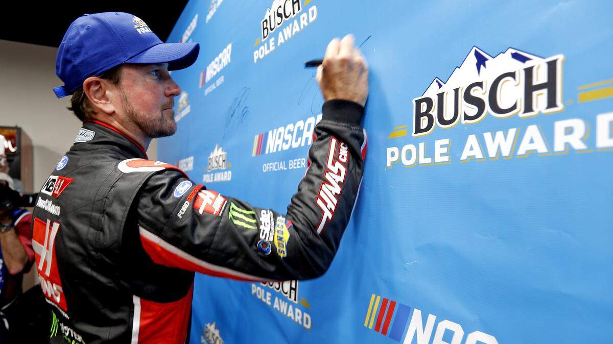 Kurt Busch signs the pole award banner after taking the pole position of the Monster Energy Nascar Cup Series at Texas Motor Speedway Friday April 06, 2018. Busch had a lap time of 27.360 and speed of 197.368 as qualifying was called after round one due to bad weather.