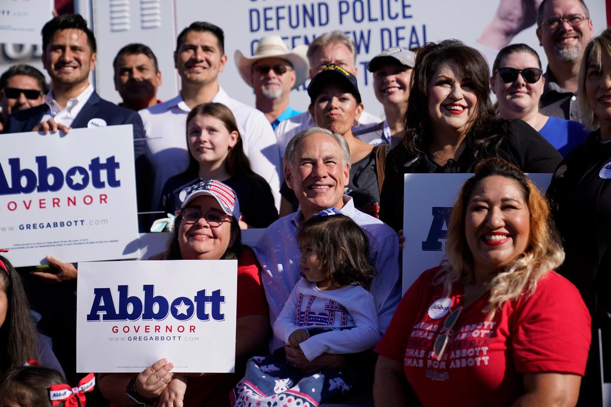 Texas Gov. Greg Abbott, center, poses with supporters as prepares to canvass for votes, Saturday, Oct. 1, 2022, in Harlingen, Texas. As Democrats embark on another October blitz in pursuit of flipping America’s biggest red state, Republicans are taking a swing of their own: Making a play for the mostly Hispanic southern border on Nov. 8 after years of writing off the region that is overwhelmingly controlled by Democrats. (AP Photo/Eric Gay)