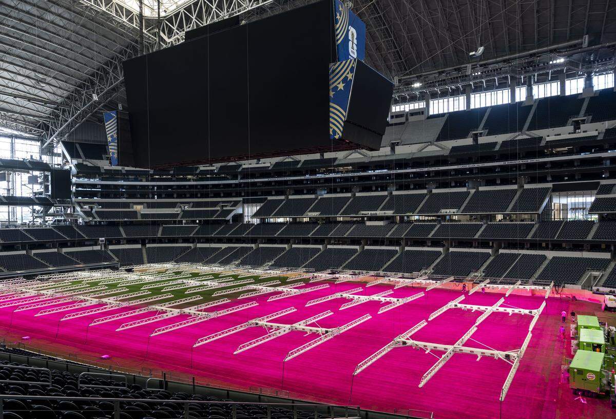 LED grow lights illuminate the pitch inside Dallas Stadium, where preparations are underway for FIFA World Cup 2026 on Thursday, May 14, 2026 in Arlington, Texas. Ewen Hodge, head of pitch infrastructure, said it is the first time grow lights have been suspended in a stadium.