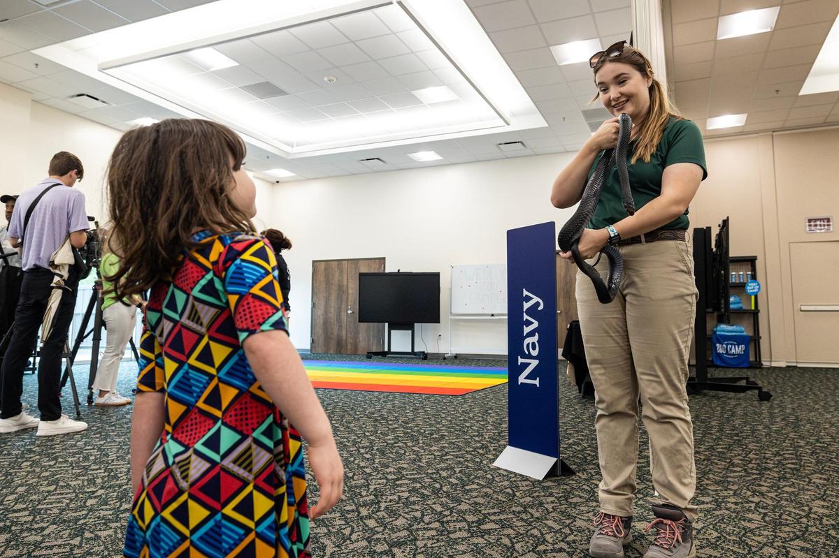 Charlotte Smith, 3, learns about Boba, an Eastern Indigo Snake, from animal trainer Kailee Strain during the grand opening of the new Fort Worth Zoo Exploration & Learning Center on Thursday, May 30, 2024.