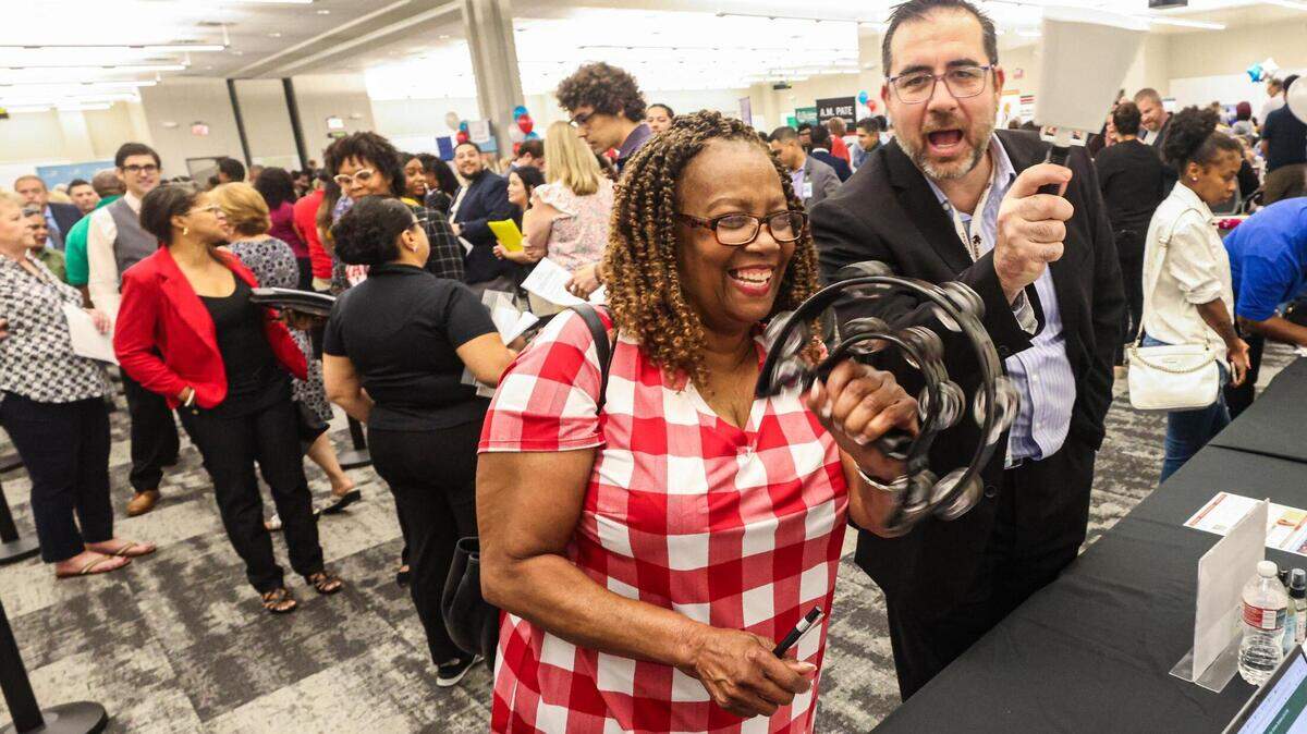 Hazel Hodges and John Engel, the principal at Southwest High School, celebrate after Hodges secured a teaching assistant position at Southwest during a Fort Worth Independent School District-wide teacher hiring fair at the FWISD Teaching and Learning Center on Thursday, July 27, 2023.