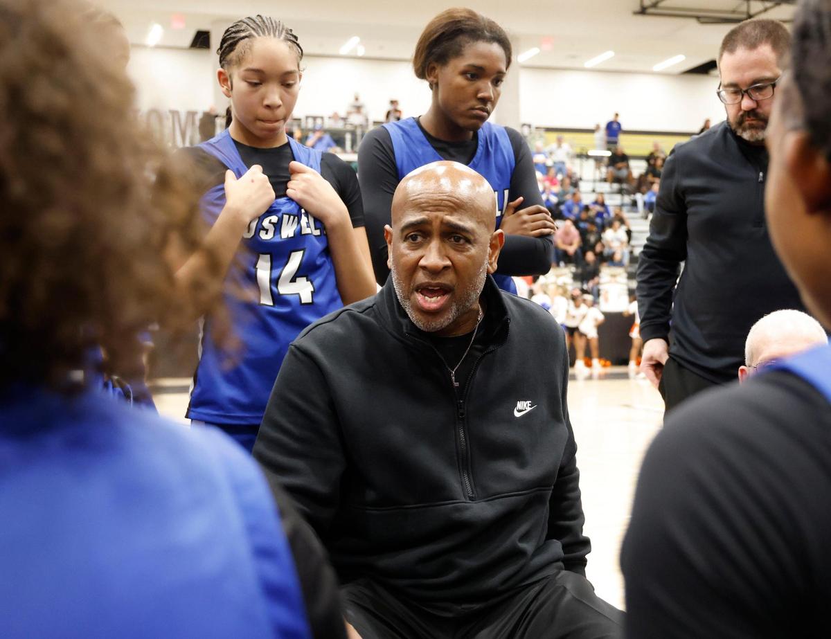 Fort Worth Boswell head coach John Reese talks to the team during the break before the fourth quarter of the UIL Class 6A D2 state semifinal girls basketball game against Lancaster at The Colony High School in The Colony, Texas, Tuesday, Feb. 25, 2025.