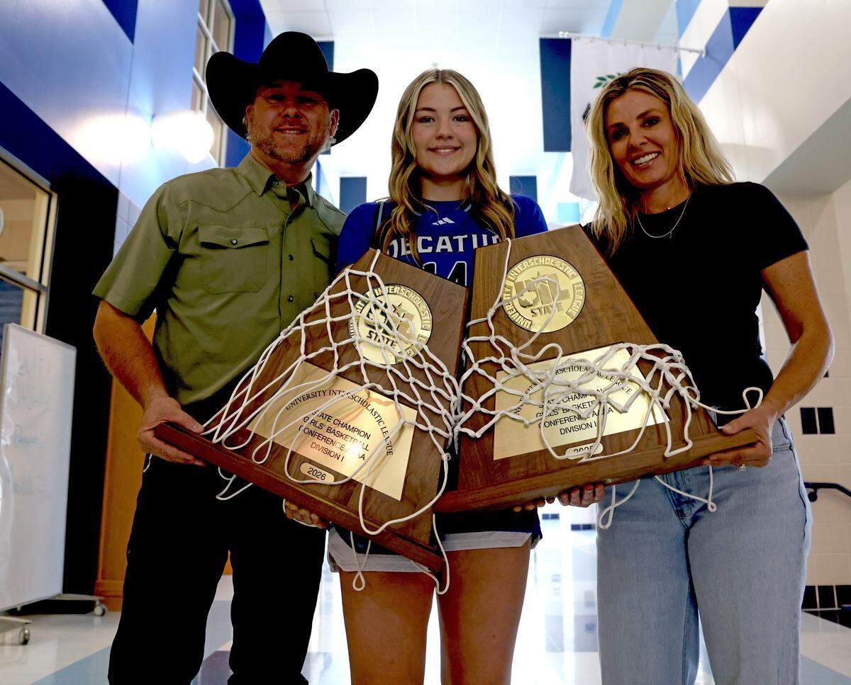 Decatur High School point guard Style Brazile photographed with her parents Shada and Trevor and the two Class 4A Division I State Championship trophies from 2025 and 2026 at Decatur High School in Decatur, Tx. Tuesday, March 31, 2026