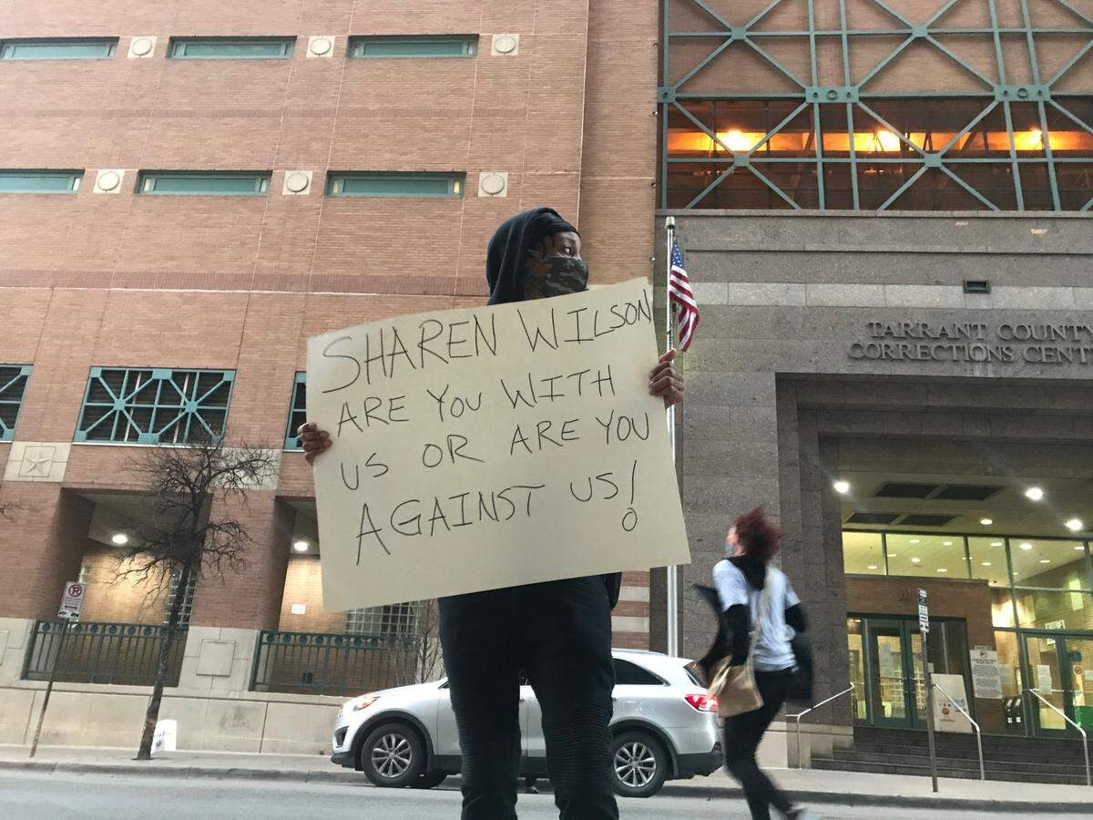 Nysse Nelson stands outside of the District Attorney’s Office in downtown Fort Worth, Texas on March 16, 2021, holding up a sign directed at District Attorney Sharen Wilson. She helped organize a protest calling for an immediate date in the trial against the officer who shot and killed Atatiana Jefferson in October 2019.