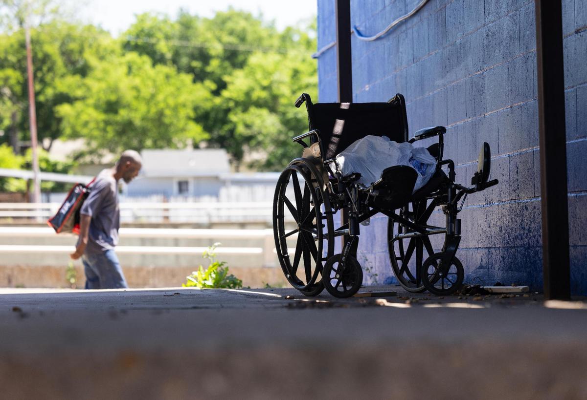 A pedestrian walks by an abandoned wheel chair in the back of Extra Care Concerns on East Lancaster Street. Criminal activity around the clinic is prompting the owners to considering moving.