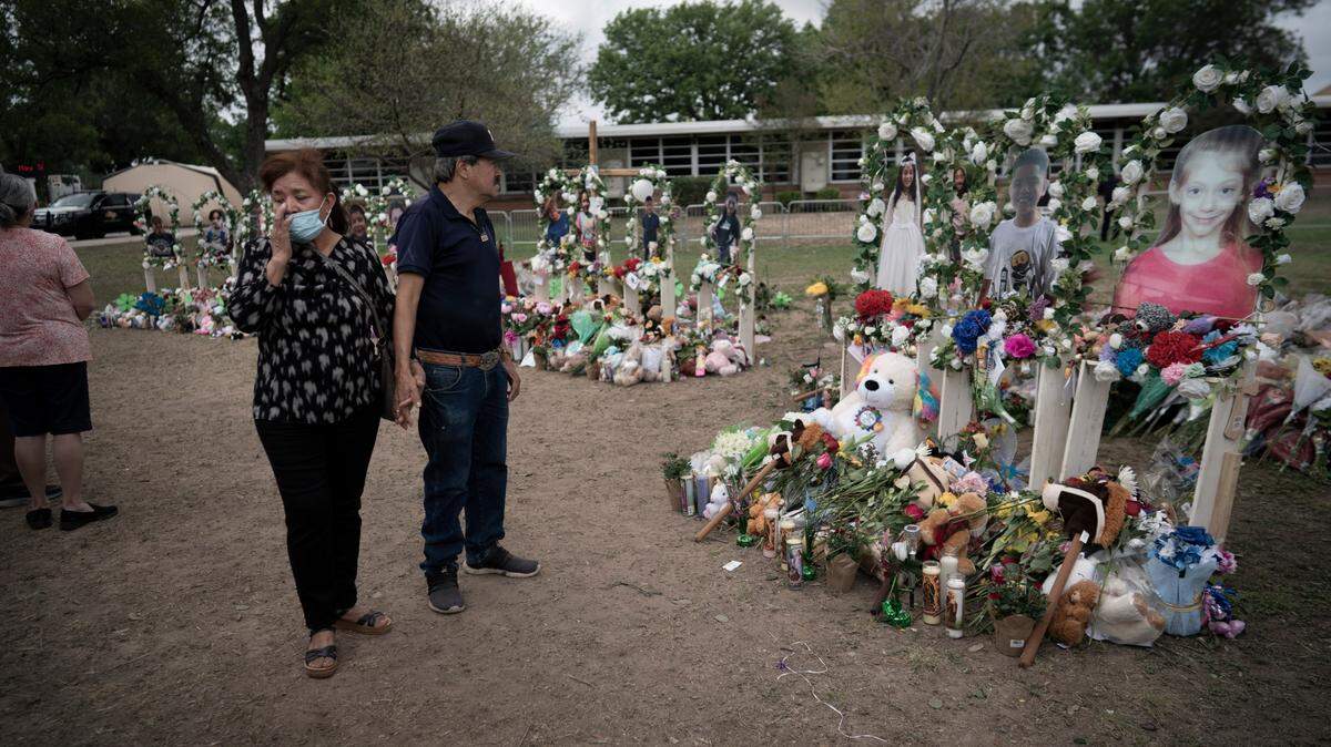 People visit a memorial outside Robb Elementary School in Uvalde, Texas, Monday, May 30, 2022. On May 24, 2022, an 18-year-old entered the school and fatally shot 19 children and two teachers. (AP Photo/Wong Maye-E)
