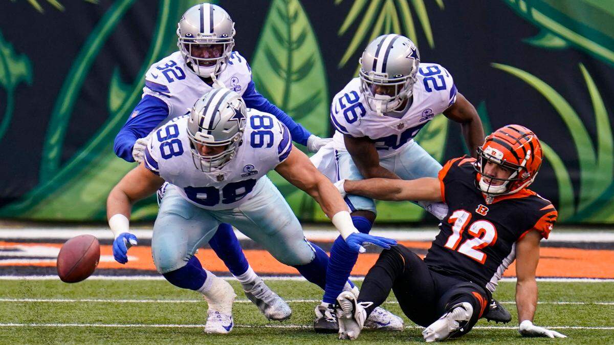 Cincinnati Bengals wide receiver Alex Erickson (12) fumbles the ball in the first half of an NFL football game against the Dallas Cowboys in Cincinnati, Sunday, Dec. 13, 2020. The Cowboys recovered. (AP Photo/Bryan Woolston)