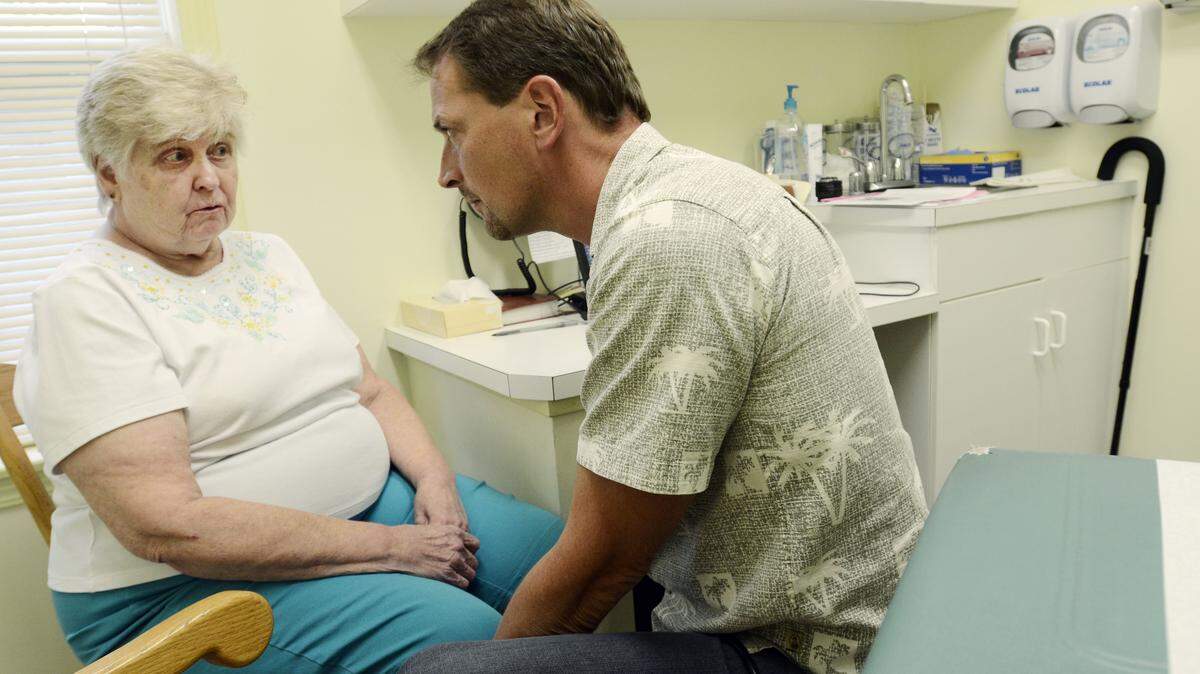 Dr. Joseph Hinterberger discusses care with Mary Ann Zebrowski in 2014 at his practice in Dundee, N.Y.