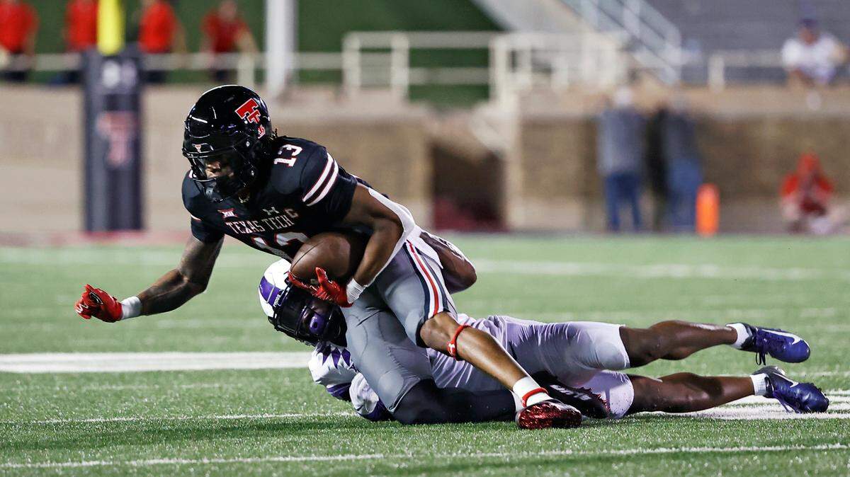 TCU’s Tre’Vius Hodges-Tomlinson (1) tackles Texas Tech’s Erik Ezukanma (13) in a 2021 game in Lubbock.