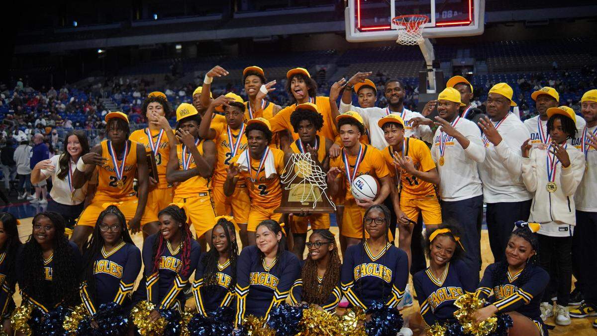 The Dallas Oak Cliff Faith Family Academy basketball team takes a team photo after defeating Silsbee in the Class 4A state championship game on Saturday, March 9, 2024 at the Alamodome in San Antonio, Texas. Faith Family won 80-66.